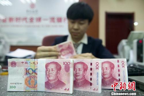 11月5日，人民幣中間價(jià)漲勢(shì)延續(xù)。中國外匯交易中心報(bào)人民幣對(duì)美元匯率中間價(jià)為6.8976，較前一交易日大幅上調(diào)395個(gè)基點(diǎn)，重新返回6.8區(qū)間，創(chuàng)下近一個(gè)月以來的最高值。圖為11月1日，山西太原一銀行工作人員正在清點(diǎn)貨幣。<a target='_blank'  data-cke-saved- ><p  align=